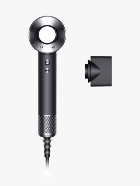 Dyson Supersonic Origin Hair Dryer in branded component with attachment on a light gray background