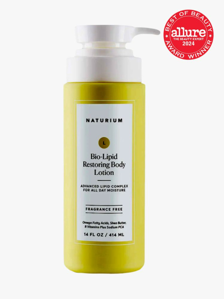 body lotion in branded yellow bottle with white pump on light gray background with red and white 2024 allure best of beauty seal