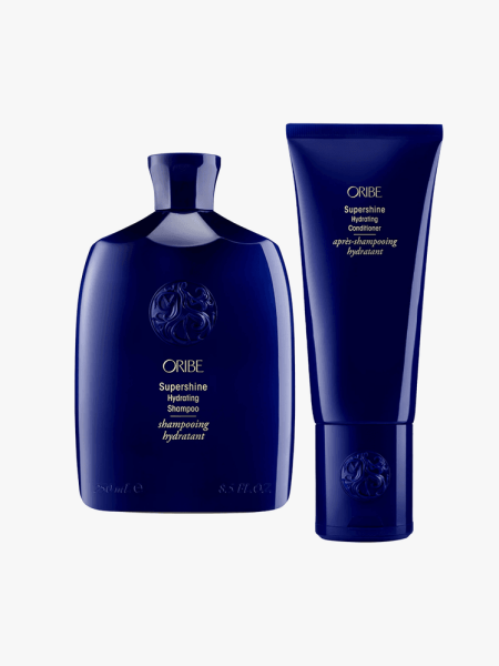 Oribe Hydrating Supershine Shampoo & Conditioner on a grey background